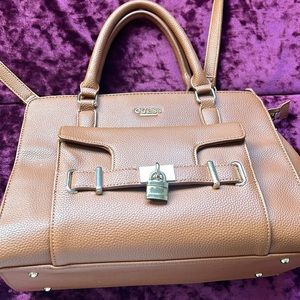 Darker beige,large purse. Guess brand. Just a few years old, great for traveling